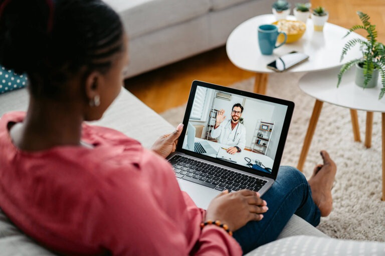 Patient having a virtual video visit with a doctor on a laptop