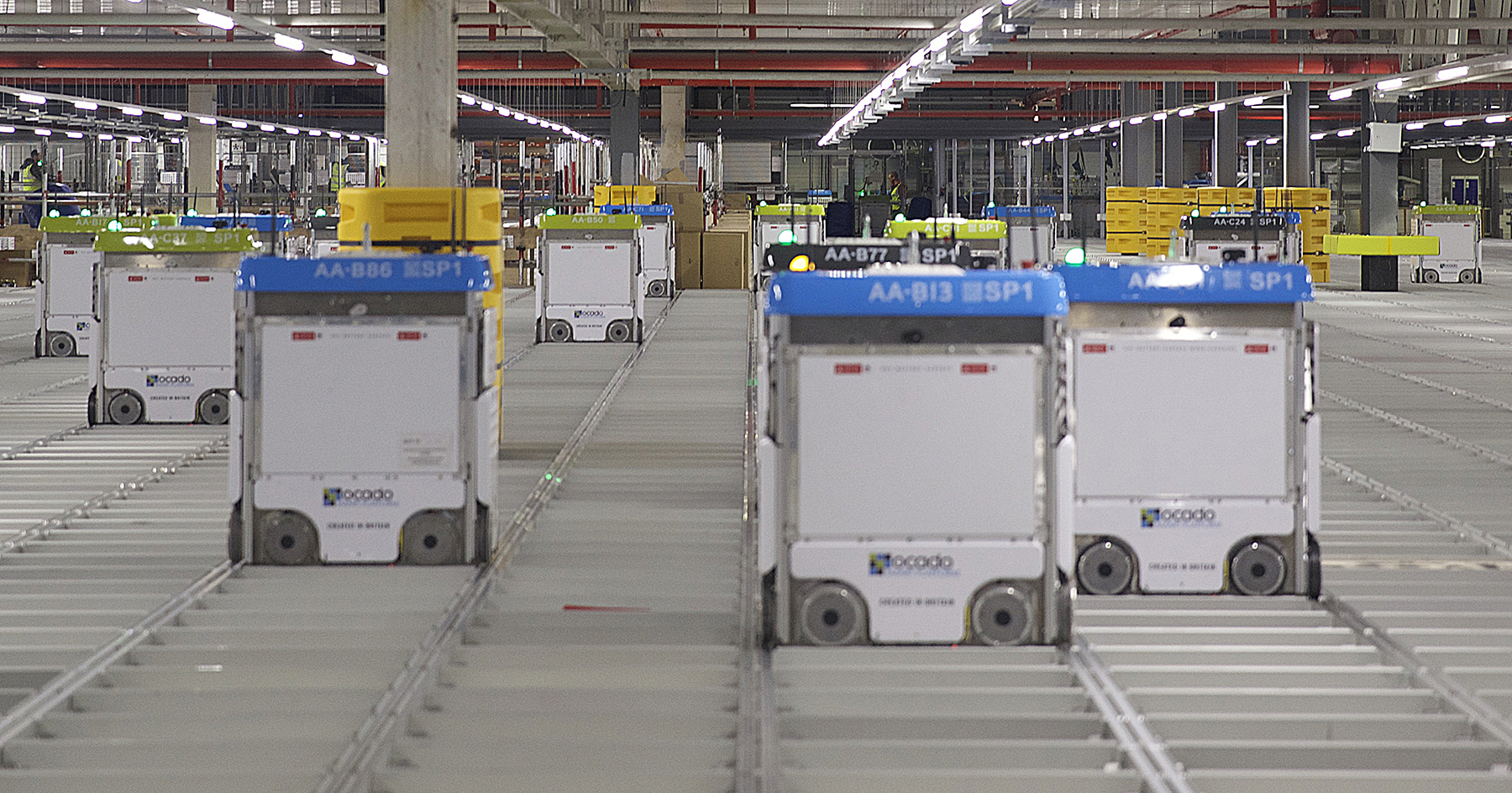 Warehouse robots operating on an automated grid system