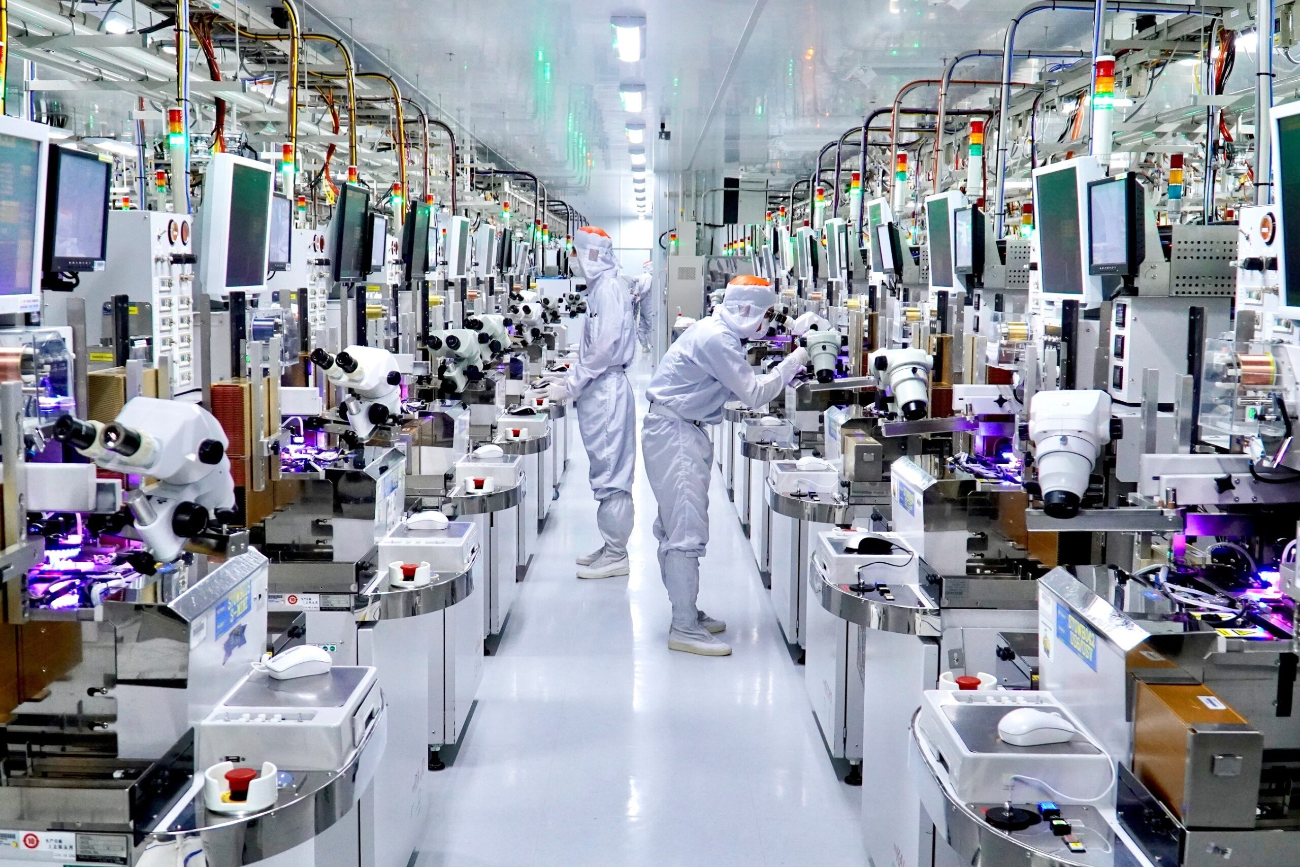 Engineer inspecting semiconductor manufacturing equipment