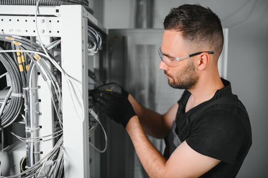 Technician connecting network equipment in a data center