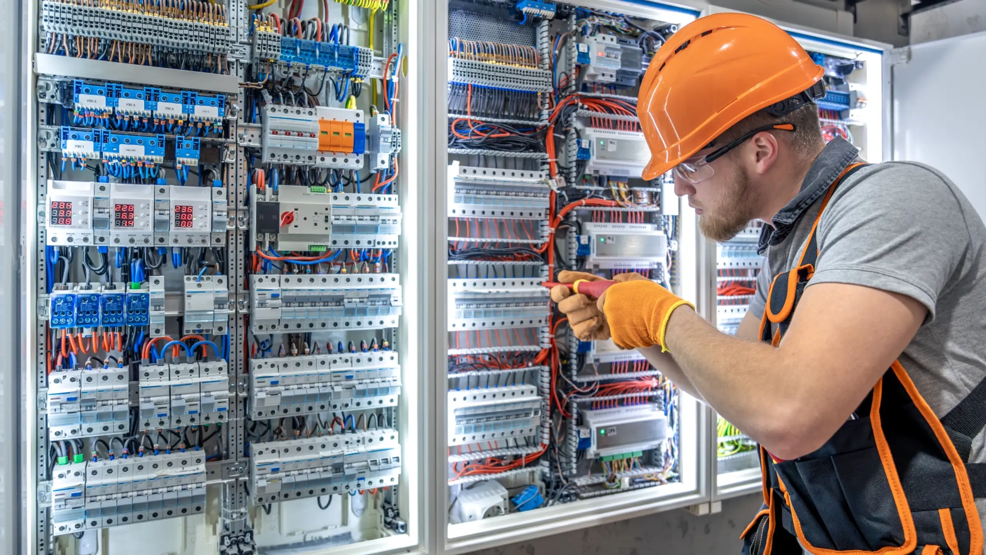 Skilled trades worker installing electrical panel