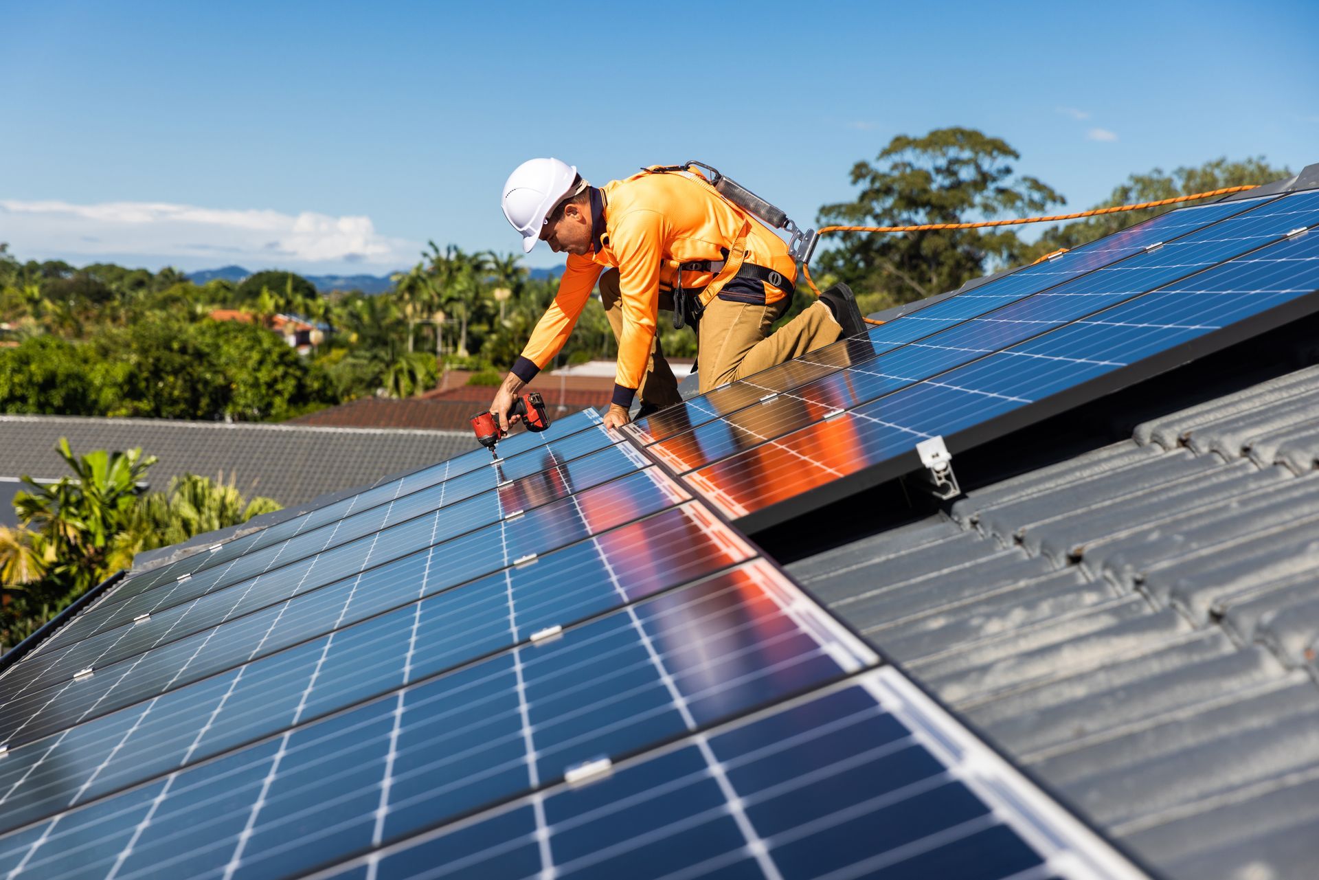 worker installing solar panel roof